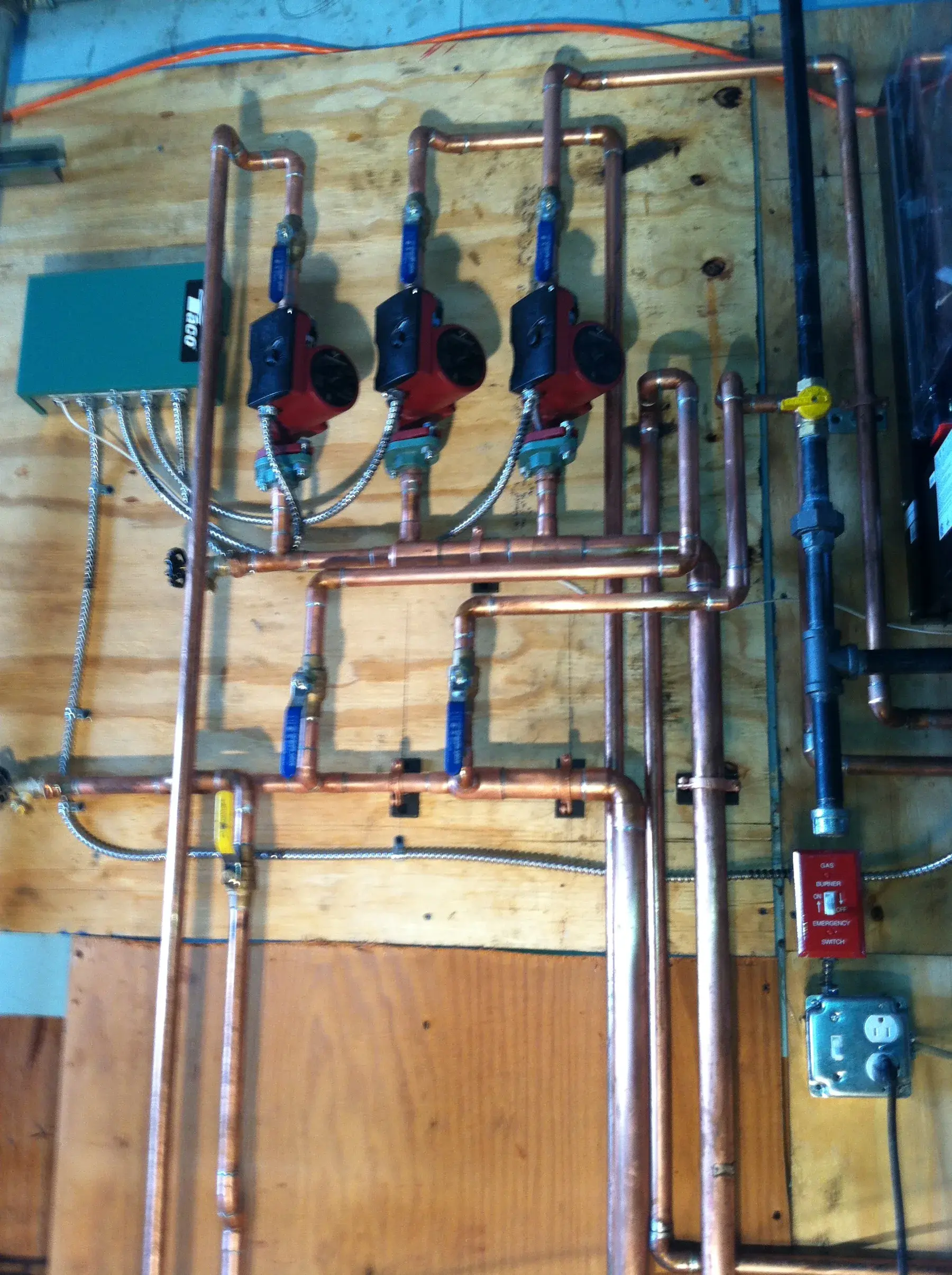 Copper heating manifold with three circulation pumps and isolation valves